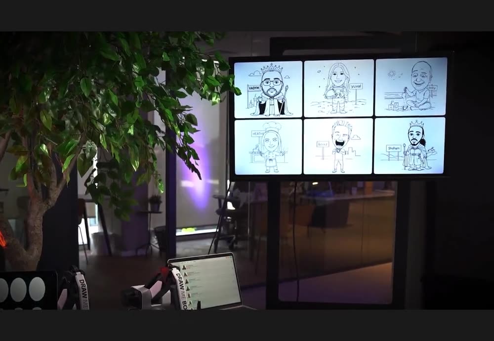 Draw-Me-Bot sketching guest portraits onto the display wall at an event